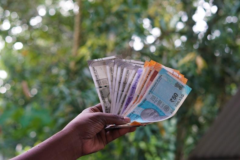 Farmer holding earnings from increased agricultural income
